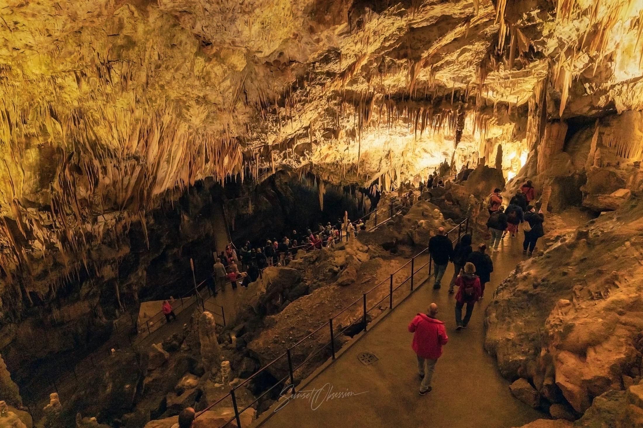 Descending into Postojna Cave