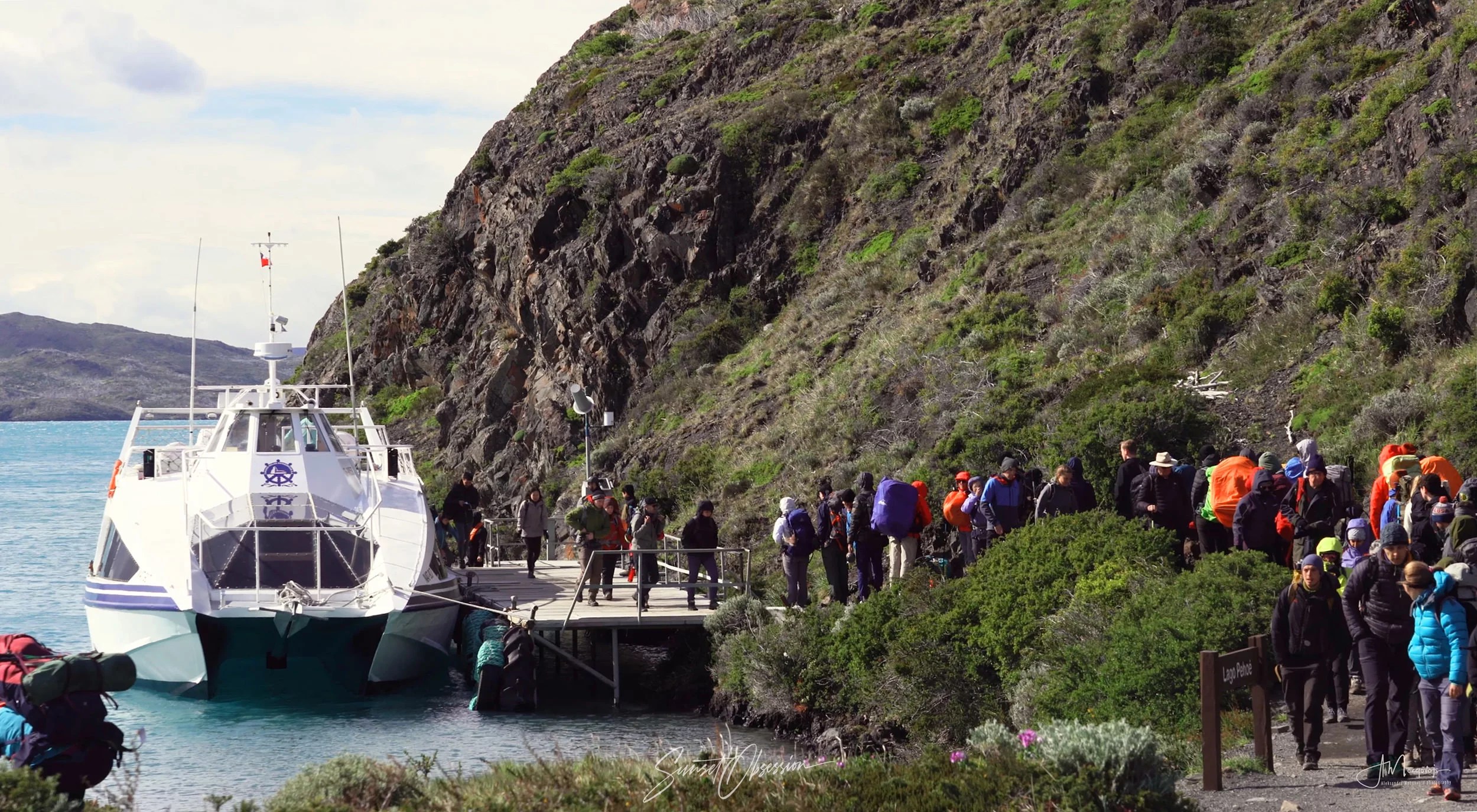 Hikers disembarking Pudeto Catamaran at Paine Grande, French Valley hike in Torres del Paiine